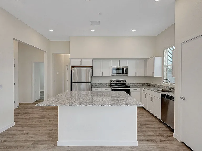 Experience luxury and functionality in this sleek modern kitchen, perfect for home chefs.