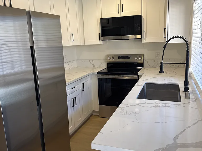Brand new kitchen with new cabinets, quartz countertop, new appliances including Samsung double door fridge/ freezer