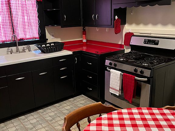 Kitchen with coffee maker, microwave, large fridge with freezer, gas stove/oven