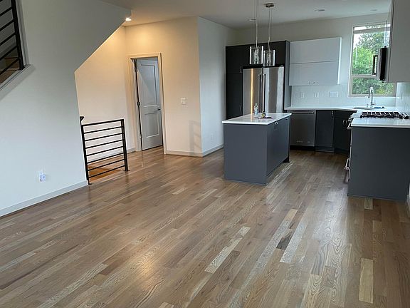 Modern chef's kitchen with upgraded appliances and an open floorplan to the living area. Half bathroom off the kitchen.
