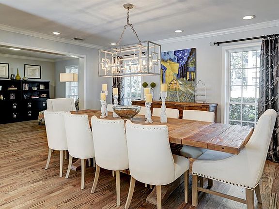 Host supper club, family dinners and game night in your delightful dining room. Custom chandelier will remain with the home.