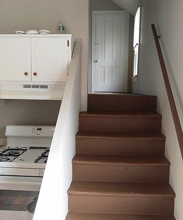 Kitchen / left where frig is are stairs to bedroom