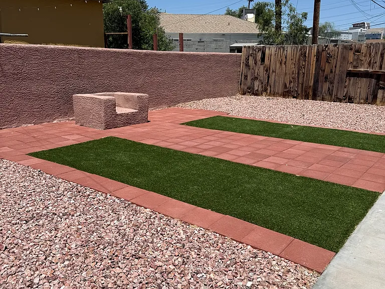Private outdoor patio area with low-maintenance landscaping and space to relax or unwind