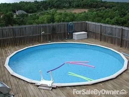 Pool : The pool surrounded by deck and fence with views in background.
