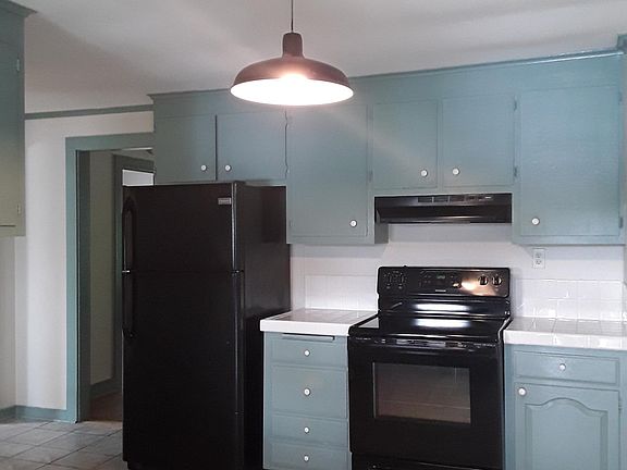 Kitchen opposite door showing entry way to living room.
