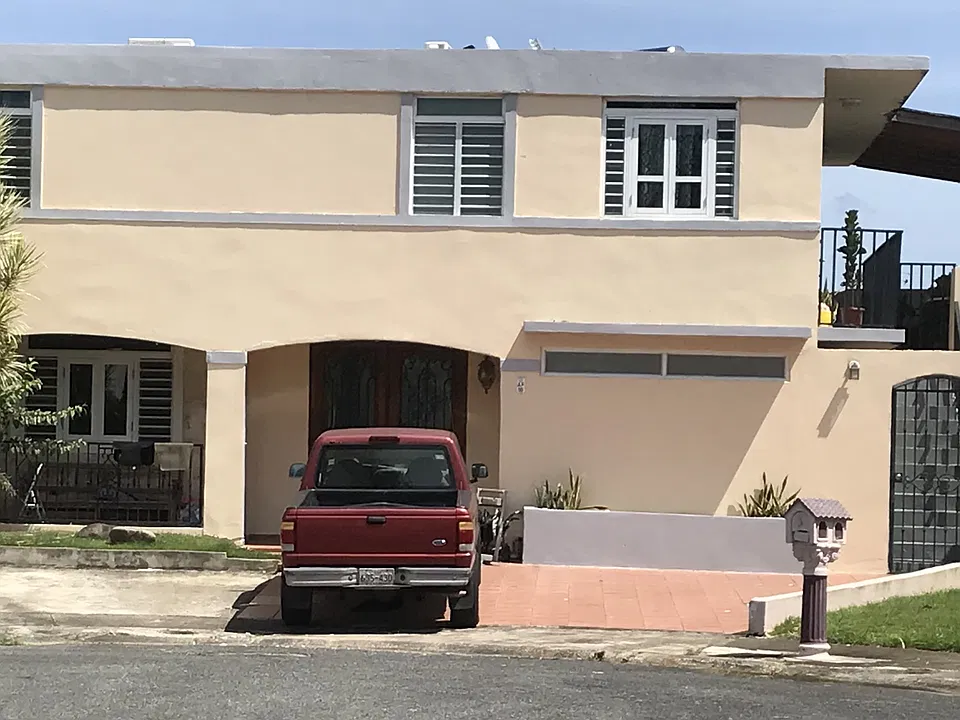 Front of the house. Apartment for rent is accessed through the side stairway. The two top windows on the right-hand side are where the apartment is located.