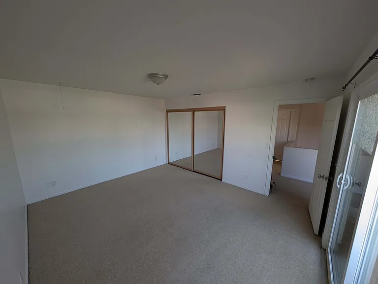 Your bedroom with freshly painted walls. There are high quality anchors ready for a TV mount in the wall across from the sliding glass door.