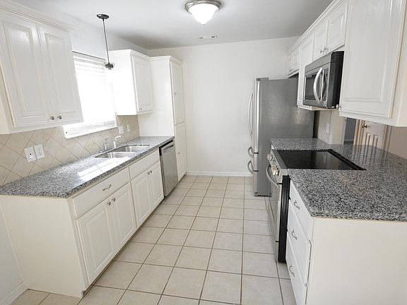Galley kitchen with new granite and stainless steel appliances