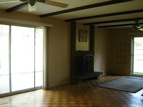 This brick fireplace and large sliding door to the back yard highlight this family room.