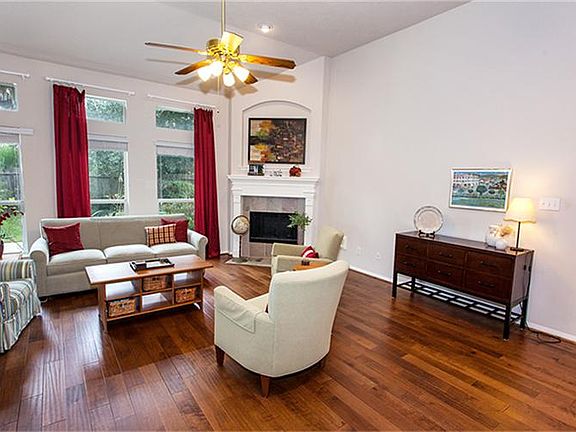 Den with beautiful wood floors