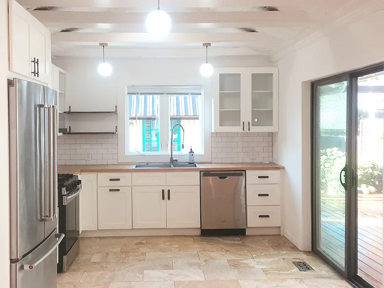 Kitchen with stainless steel fridge and dishwasher.