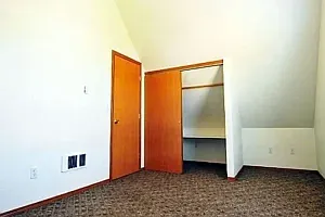 up stairs large bedroom with closet and attic storage