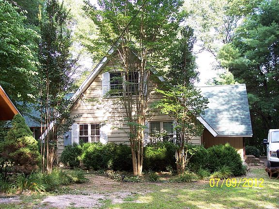 side of house with aluninum siding
						:
						view of left side of house from driveway