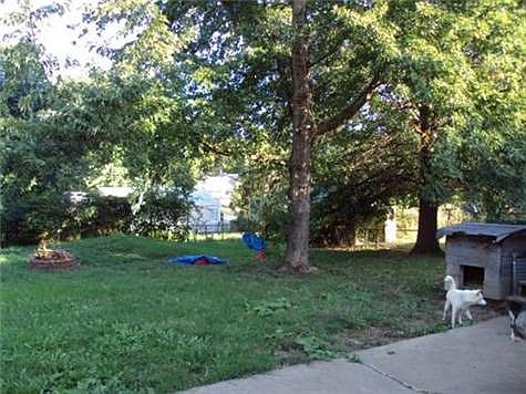 Shady back yard with fence. Deck, Shed (not in picture), patio