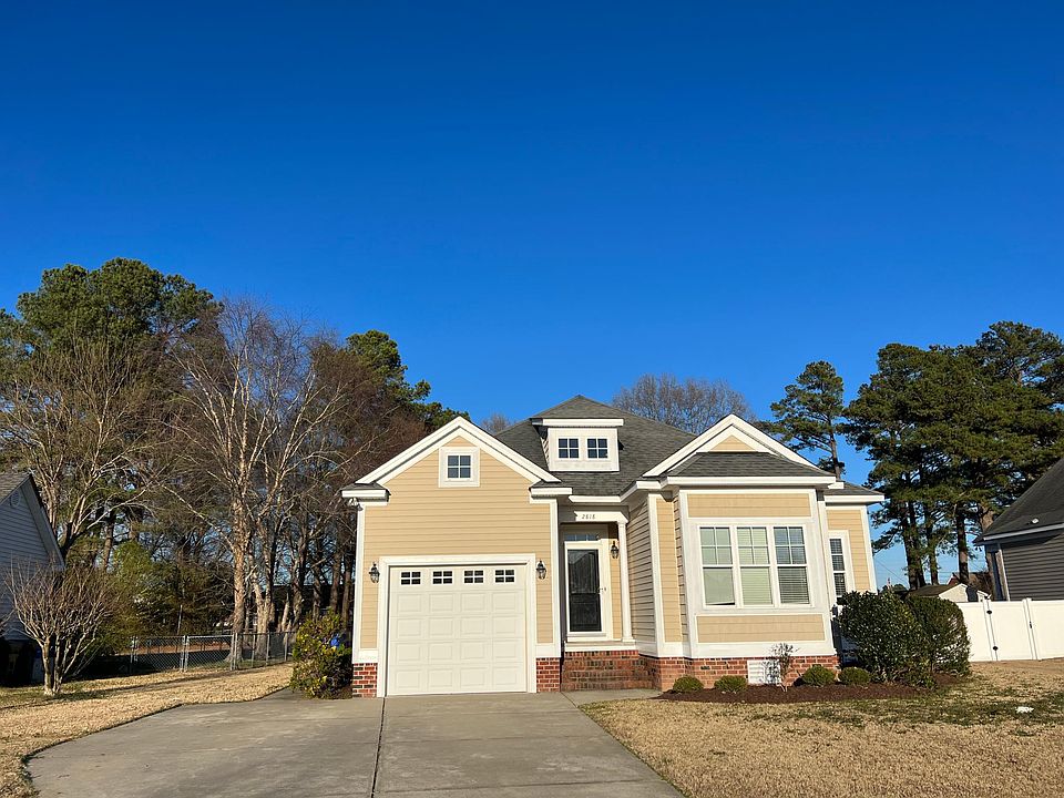 Exterior View with Paved Driveway! Garage for your Car and storage!
