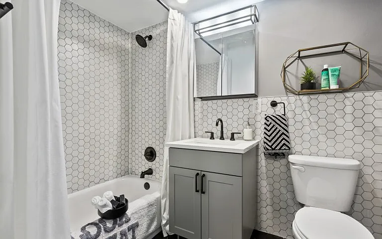 Designer bathroom with elegant all-white bath