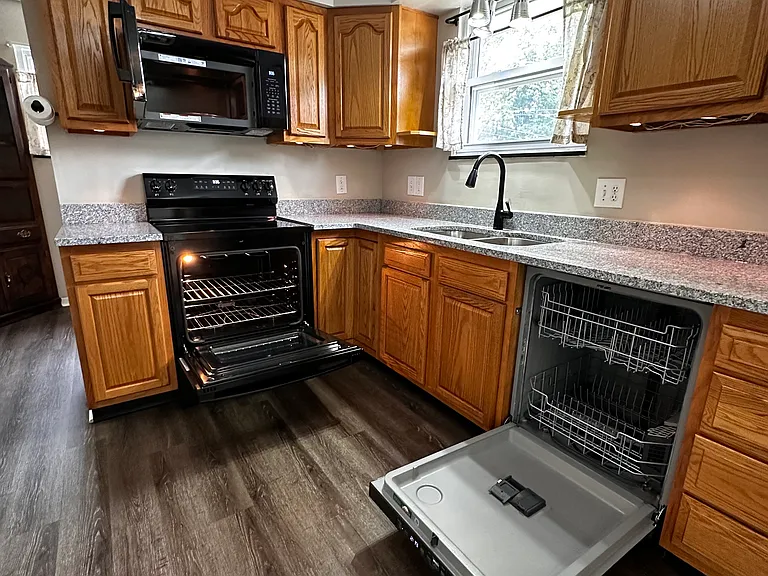Appliances pictured, granite countertop, 60/40 sink and faucet installed in July 2026.