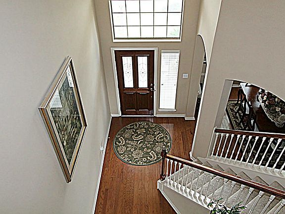 OPEN THE LEAD GLASS DOOR TO THIS GRAND TWO STORY FOYER WITH GLEAMING HARDWOOD FLOORS, ARCHWAYS AND CROWN MOLDING