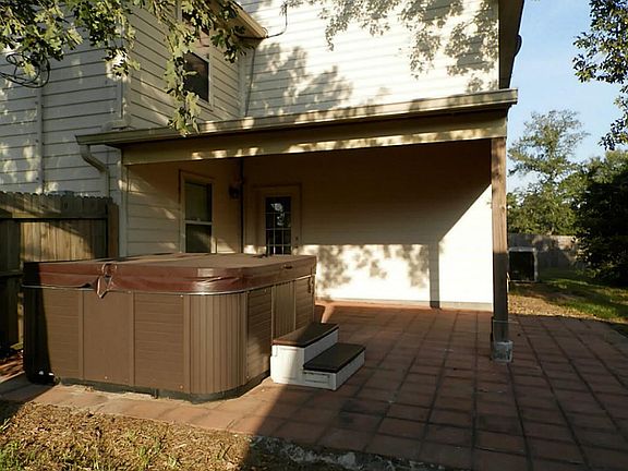 View of back patio with hot tub.  Bring your grill. Great for entertaining.  Has cable connection for TV.