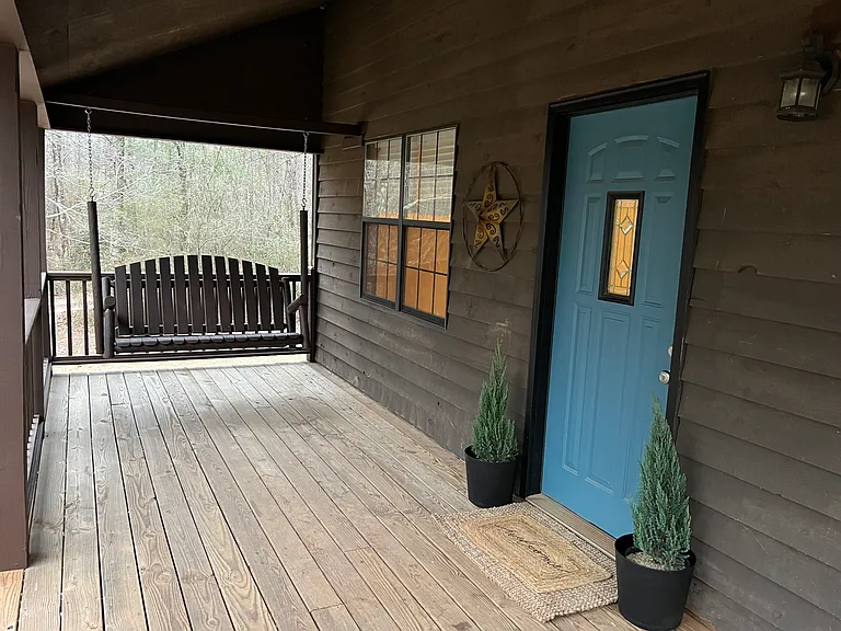 Front porch, front door, and swing.