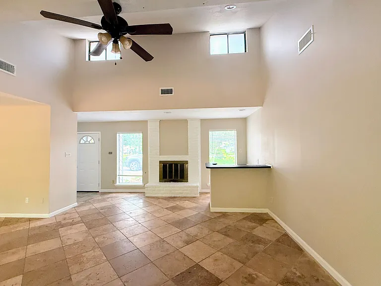 Spacious living room featuring a wet bar, fireplace, and open sightlines