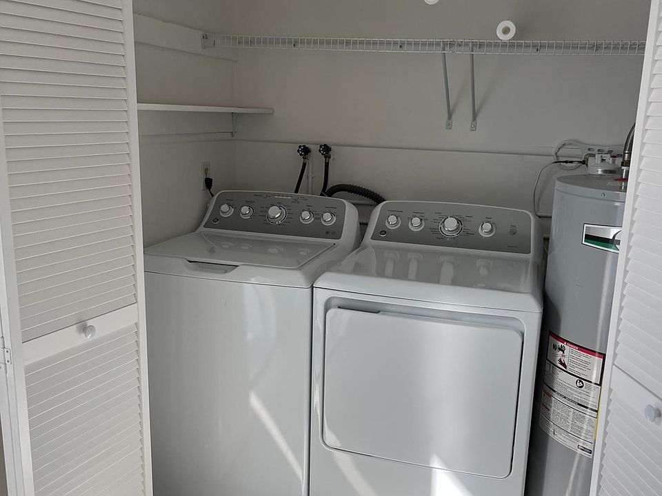 laundry closet located in back bedroom