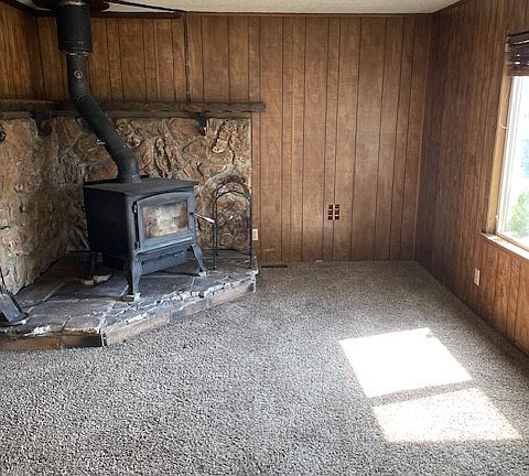 Cozy living area, just off of the dining room with a wood burning stove to keep the place warm and cozy! Currently, this room is furnished.