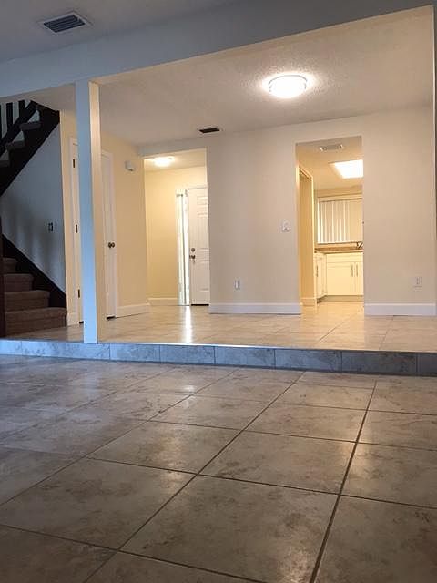 View from living room looking at dining room, kitchen and front door.