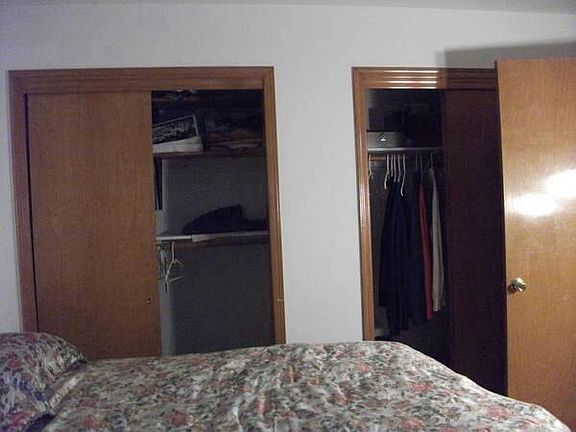 two custom double closets in queen size bedroom