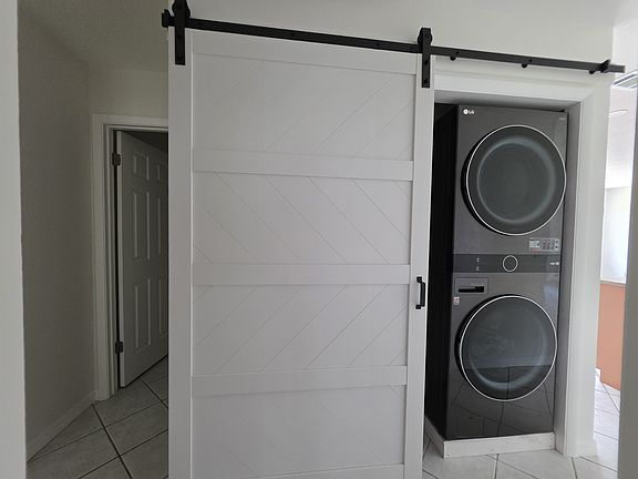 New washer and dryer with sliding barn door