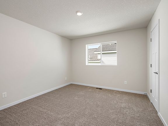 The secondary bedroom has carpet