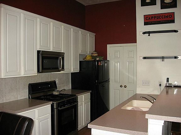 Lots of cabinet and counter space in the kitchen too! Utility room through the doors off the kitchen
