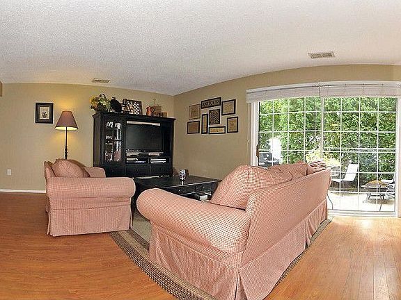 Living Room with sliders to private tree lined patio