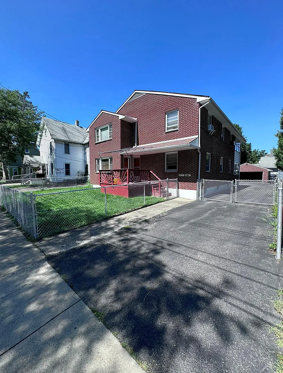 View of totally fenced in property, including driveway gate
Seating available on front porch /viewing - 10 Serrell Ave #1