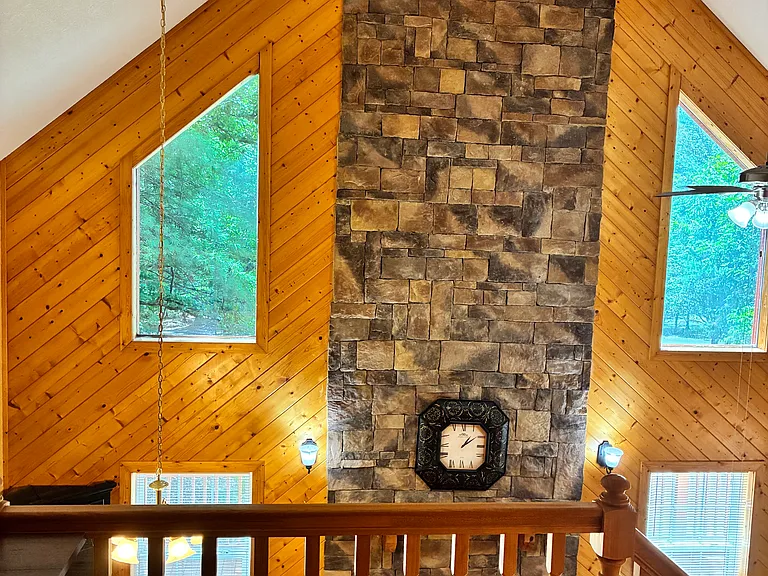View of the fireplace and living room from the loft