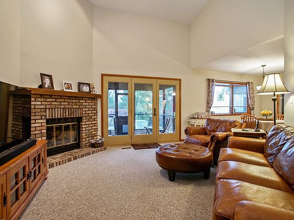 Vaulted ceilings, open concept family room w/ door to screened-in patio