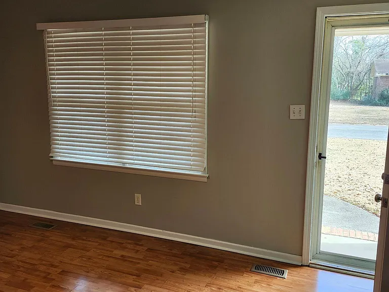 Living Room view with door opened; sunshine & screened door.