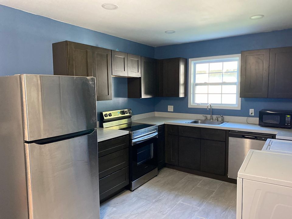 Kitchen with washer/dryer/dishwasher, oven, and fridge
