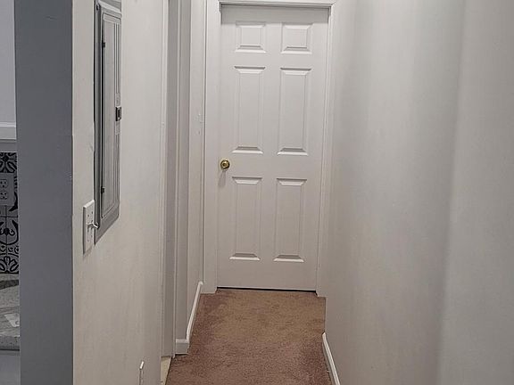 Hallway to main Qns size bedroom, bathroom and to basement