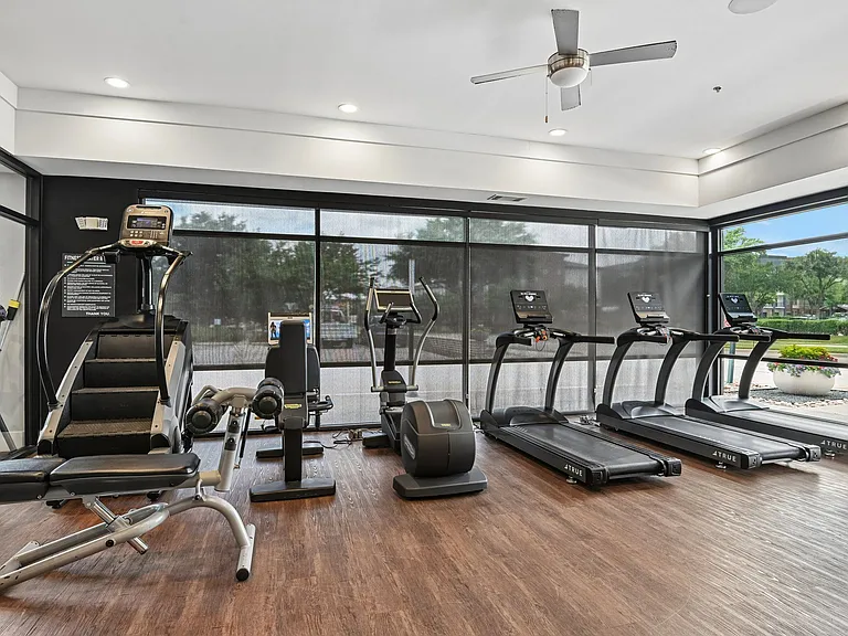 Markethaus 3700 Plano Texas A gym with treadmills, elliptical machines, and a weight bench.
