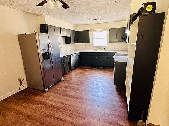 Kitchen complete with stainless steel dishwasher and refrigerator, stove also included