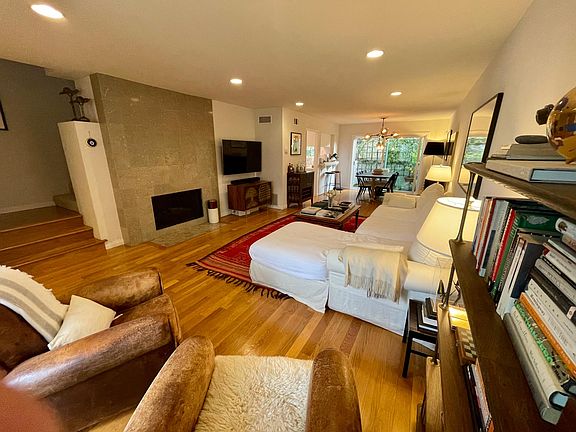 Living room with fireplace and Dining area in background