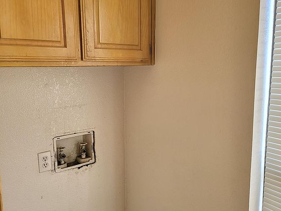 Washer hook ups in laundry nook.