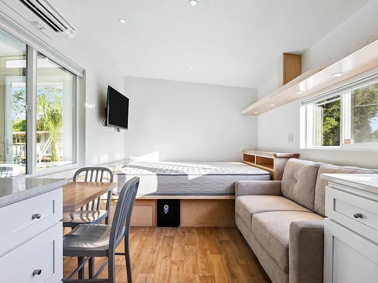 Open Layout with Queen Bed, Smart TV, Flip-Tables and Couch