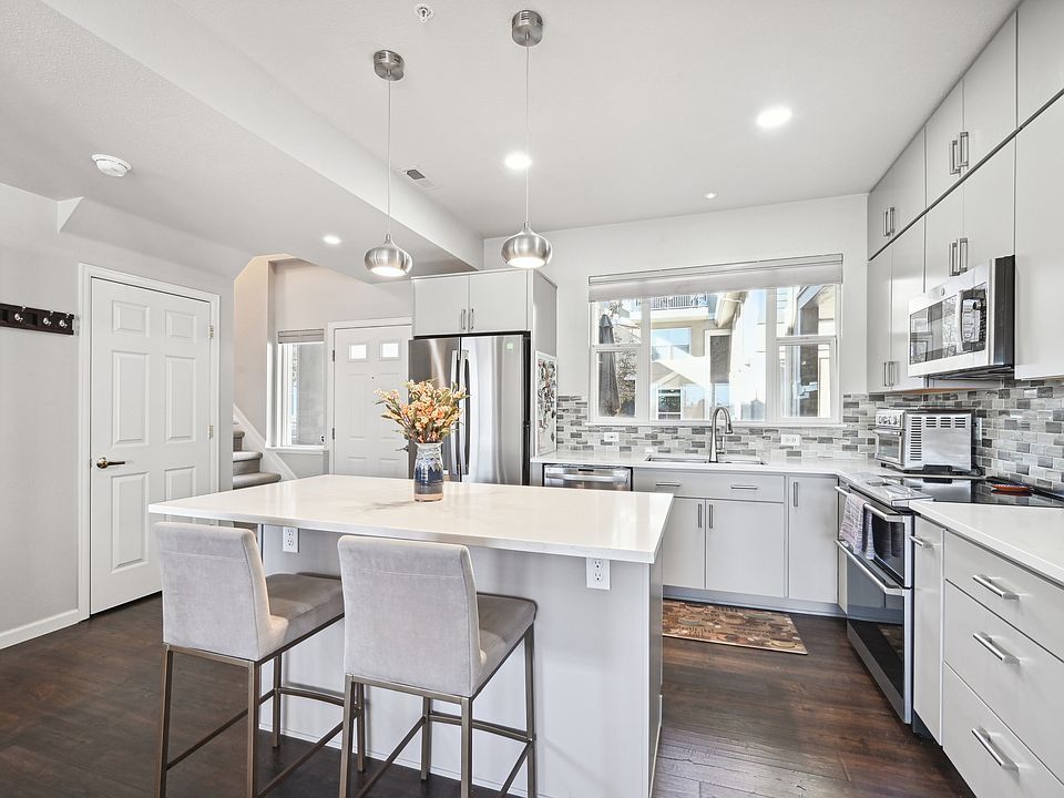 Renovated kitchen with stainless steel appliances and quartz countertops