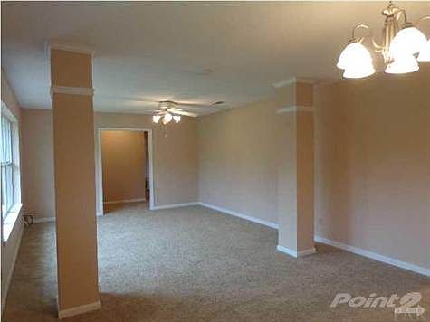 Looking back from the Dining Area to the Formal Living Room. Architectural columns separate the two rooms.