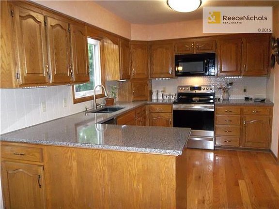 Silestone Counters, under mount stone sink, under cabinet lighting, hardwood floor.