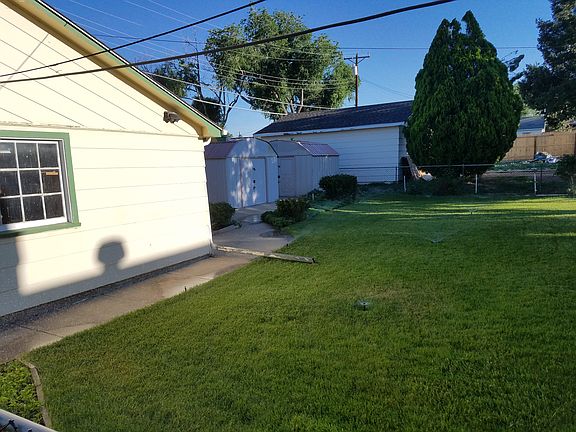 Side of garage and 2 sheds
