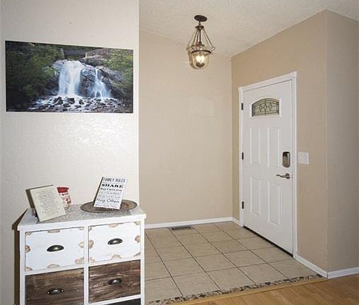 Tiled front entry with large coat closet and storage.