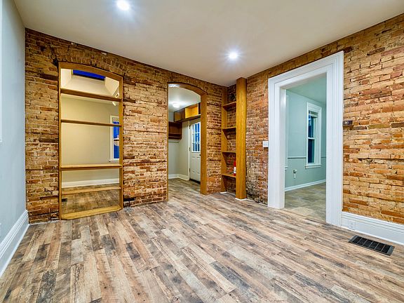 Great Room with exposed brick and new laminate flooring